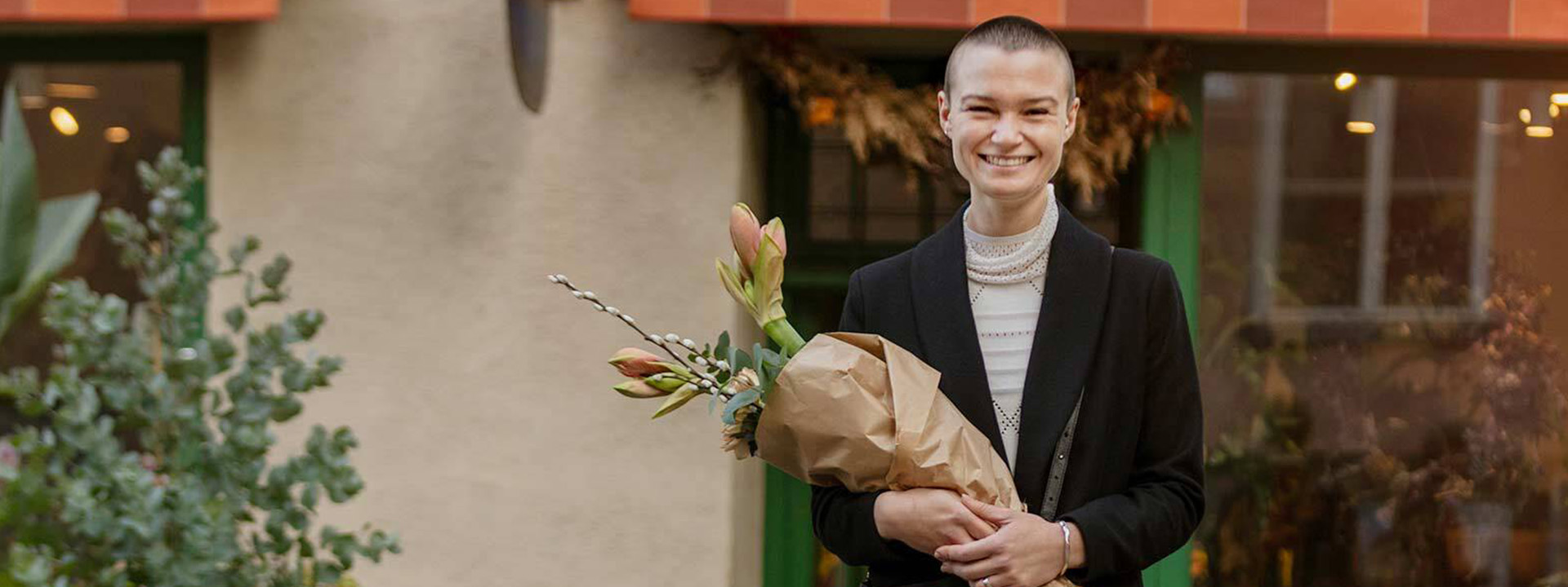 woman smiling holding flowers