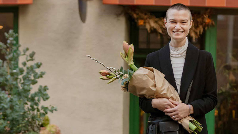 woman smiling holding flowers