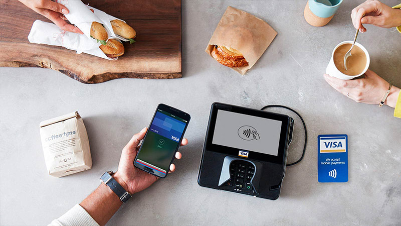 customer paying with apple pay on apple phone in cafe