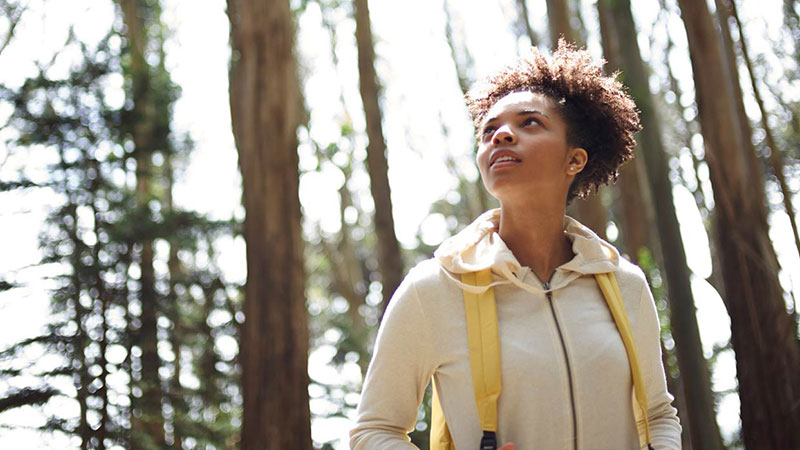 woman hiking through the woods